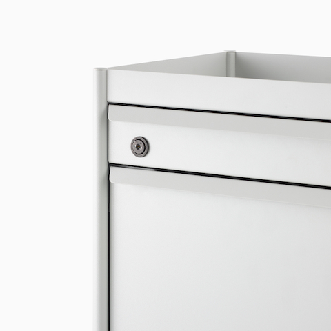 Close up image of a white individual OE1 Storage Trolley with drawer, tip-out bin and key lock, viewed from a front angle.