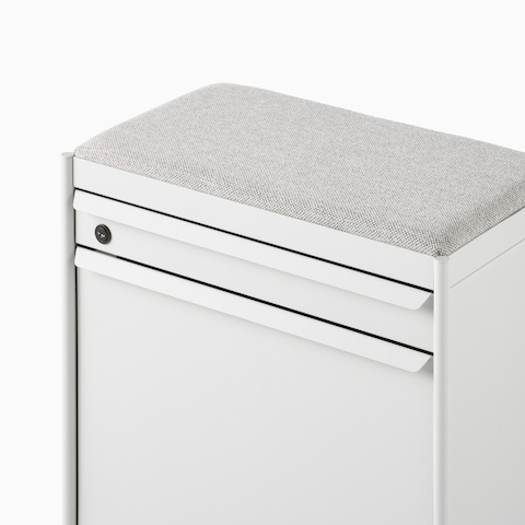 Close up image of a white individual OE1 Storage Trolley with drawer and tip-out bin, viewed from a front angle.