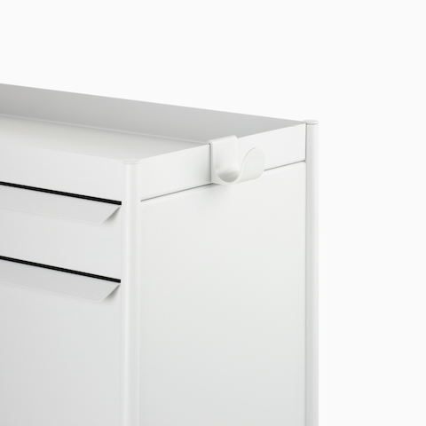 Close up image of a white individual OE1 Storage Trolley with drawer, tip-out bin and bag hook, viewed from a front angle.