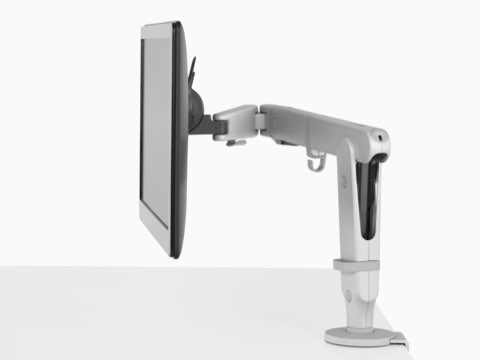 Side view of a monitor supported by a single light gray Ollin Monitor Arm.