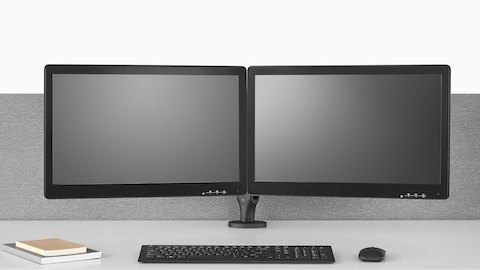 Due bracci del monitor Ollin, uno collegato a Flo Power Hub, sollevano una coppia di monitor dalla superficie di un tavolo sit-to-stand.