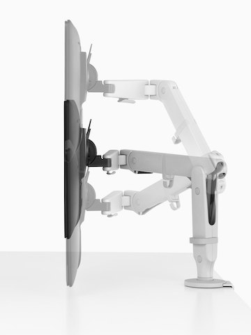 Profile view of an adjustable Ollin Monitor Arm positioning a monitor at three different heights.