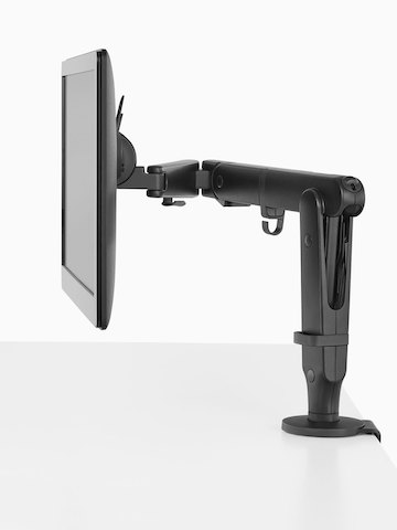 Vista de perfil de um monitor ligado a um braço de monitor Ollin preto.