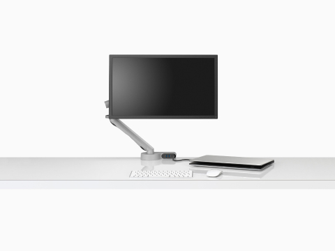 Front view of a screen attached to a Flo Monitor Arm integrated with an Ondo Connectivity Module on a desk connected to a semi-closed laptop. Front view of a screen attached to a Flo Monitor Arm integrated with an Ondo Connectivity Module on a desk connected to a semi-closed laptop.
