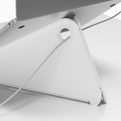 The back of an Oripura Laptop Stand with a power cable routed through its cable slots.