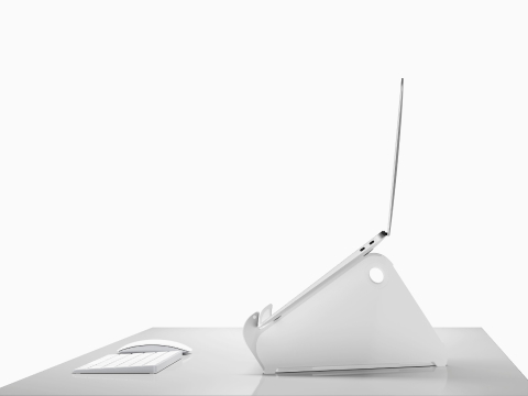 Side profile of an open and raised laptop on an Oripura Laptop Stand.