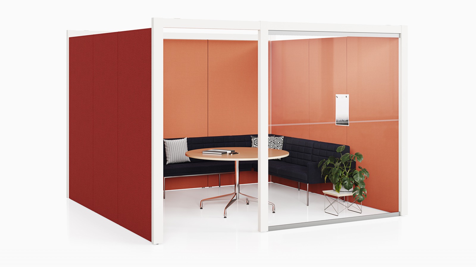 A semi-enclosed Overlay room with red tackable fabric and glass exterior walls with a couch and table inside.