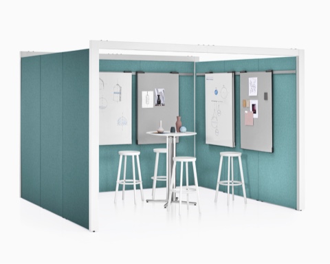 A three-sided Overlay space with green tackable fabric on the interior and exterior walls with a table, four stools, and markerboards inside. A three-sided Overlay space with green tackable fabric on the interior and exterior walls with a table, four stools, and markerboards inside.