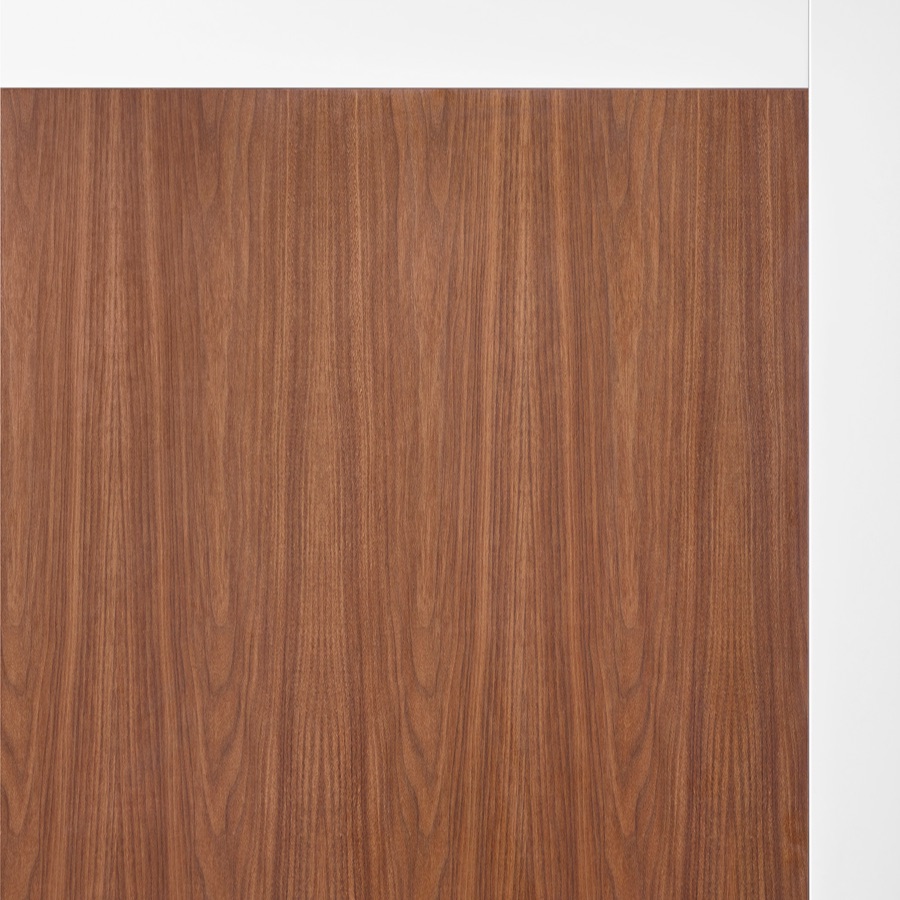 A close-up of walnut woodgrain laminate on Overlay's white structure.