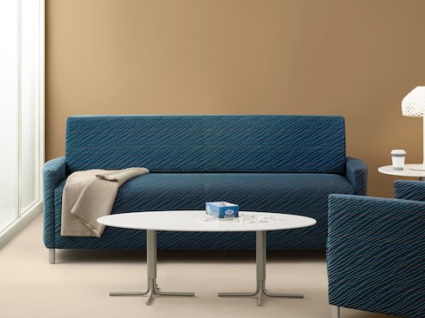 A blue Pamona Flop Sofa and complementary chair in a healthcare lounge.