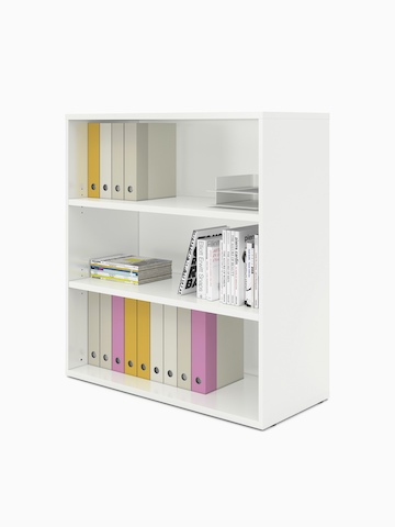 Books and binders fill an open Paragraph Storage unit with three modules and no doors, viewed at an angle.