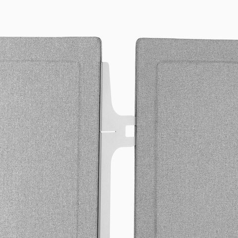 Close-up of the silver connector between two gray fabric Pari freestanding privacy screens.