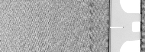 Close-up of the silver connector between two gray fabric Pari freestanding privacy screens. Close-up of the silver connector between two gray fabric Pari freestanding privacy screens.