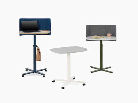 Three Passport Work Tables shown with props and various accessories in a variety of heights and finishes.
