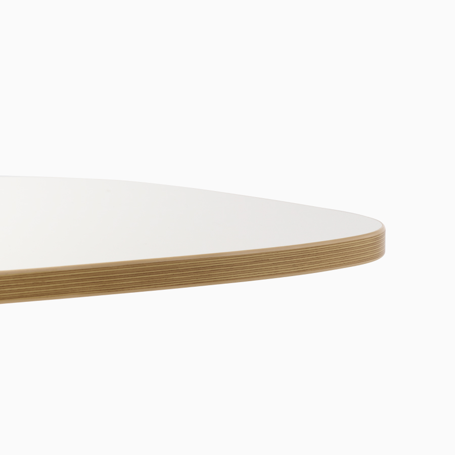 Close-up of Passport Work Table surface in white with plywood edge.