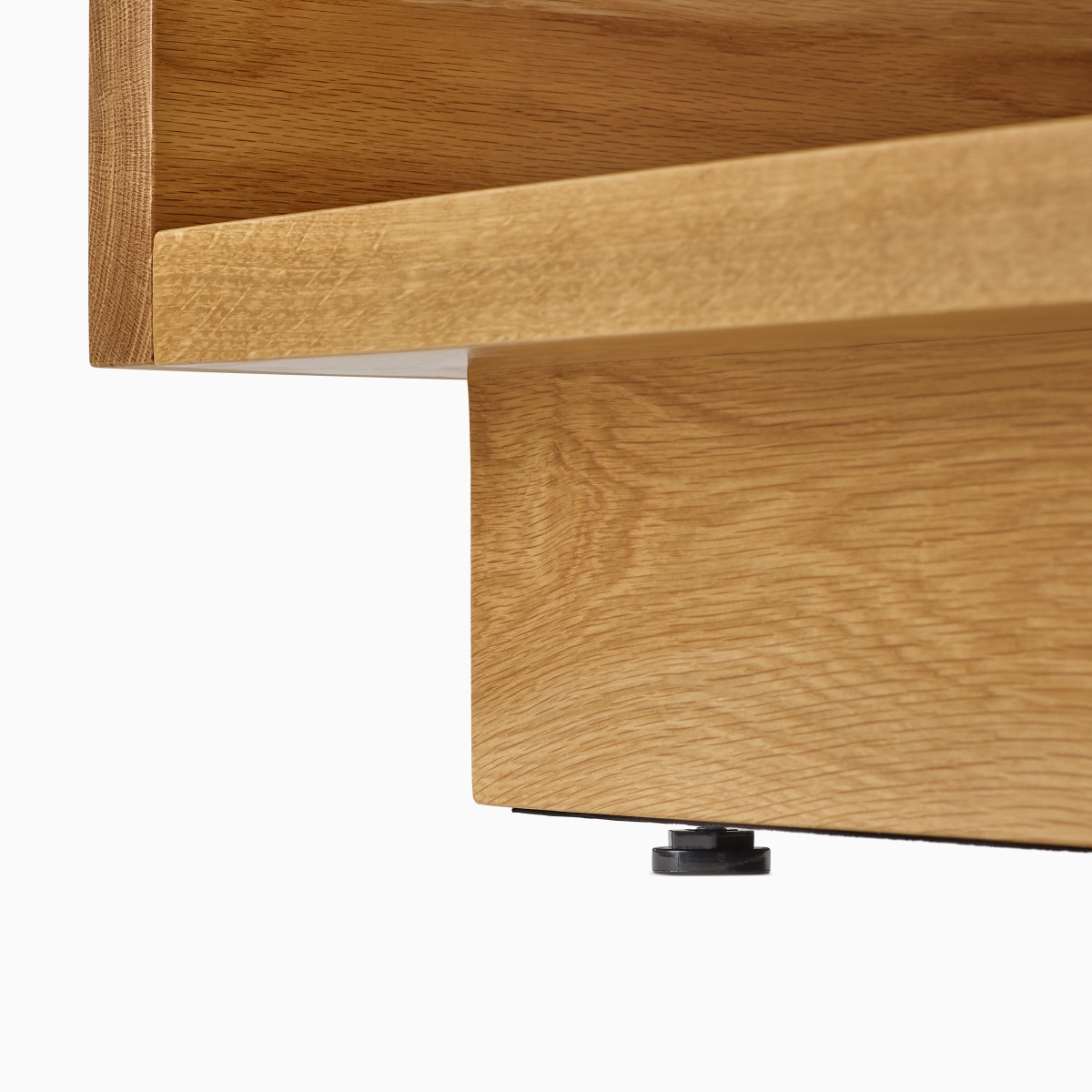 A detail view of the adjustable black foot of the Pawson Drift Sofa Group