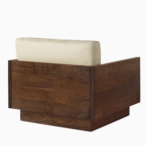 Back view of the Pawson Drift Lounge Chair in a walnut frame and beige leather cushions.
