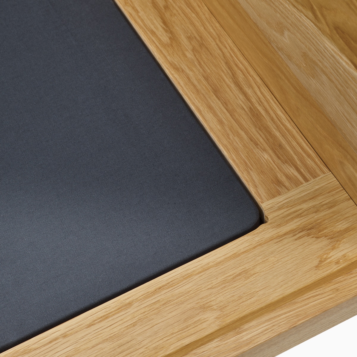 A detail view of the hidden fabric woven suspension covered by a black cotton fabric under the cushion of the Pawson Drift Sofa Group