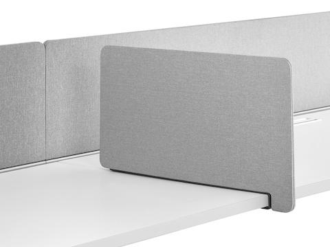 A gray fabric rectangular Personal Side Screen attached to a Layout Studio bench with a gray, flat-edge fabric, center privacy screen. A gray fabric rectangular Personal Side Screen attached to a Layout Studio bench with a gray, flat-edge fabric, center privacy screen.