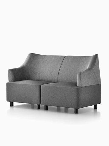 A grey Plex loveseat formed from two modular elements, viewed from a 45-degree angle.