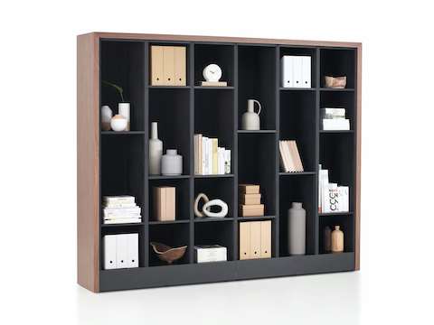 Port Storage System with a wooden frame and black shelves being used as a decorating cabinet.