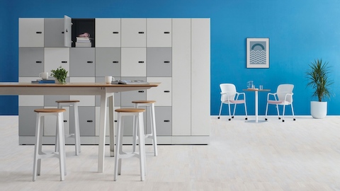 Port Storage System facing an Optimis high bench table with four Construct Stools. A round table with two Keyn Chairs is in the background. Port Storage System facing an Optimis high bench table with four Construct Stools. A round table with two Keyn Chairs is in the background.