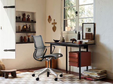 A Mode Desk and Setu Chair on a Girard Check Rug in a home office setting.