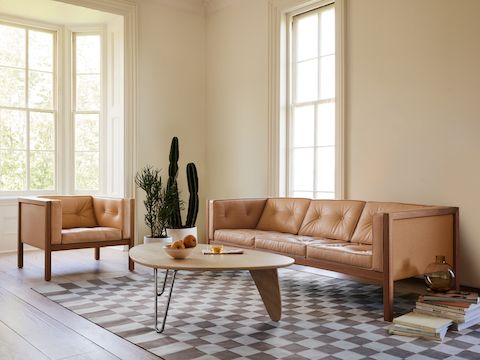 A Noguchi Rudder Table, Girard Check Rug, 80-inch Cube Sofa, and Cube Armchair in a living room setting.