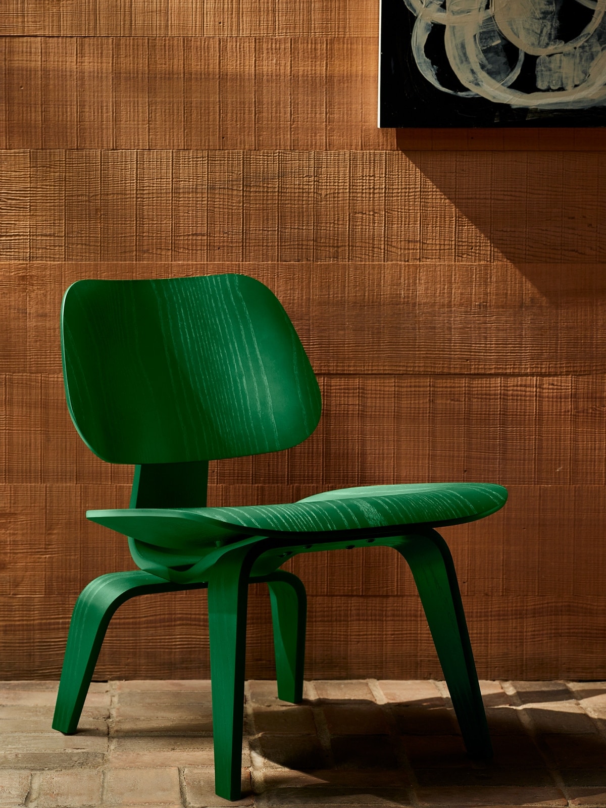 Herman Miller x HAY Eames Molded Plywood Lounge Chair in forest green.