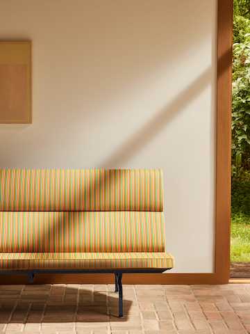 Herman Miller x HAY Eames Sofa Compact in orange Jacob's Coat fabric.