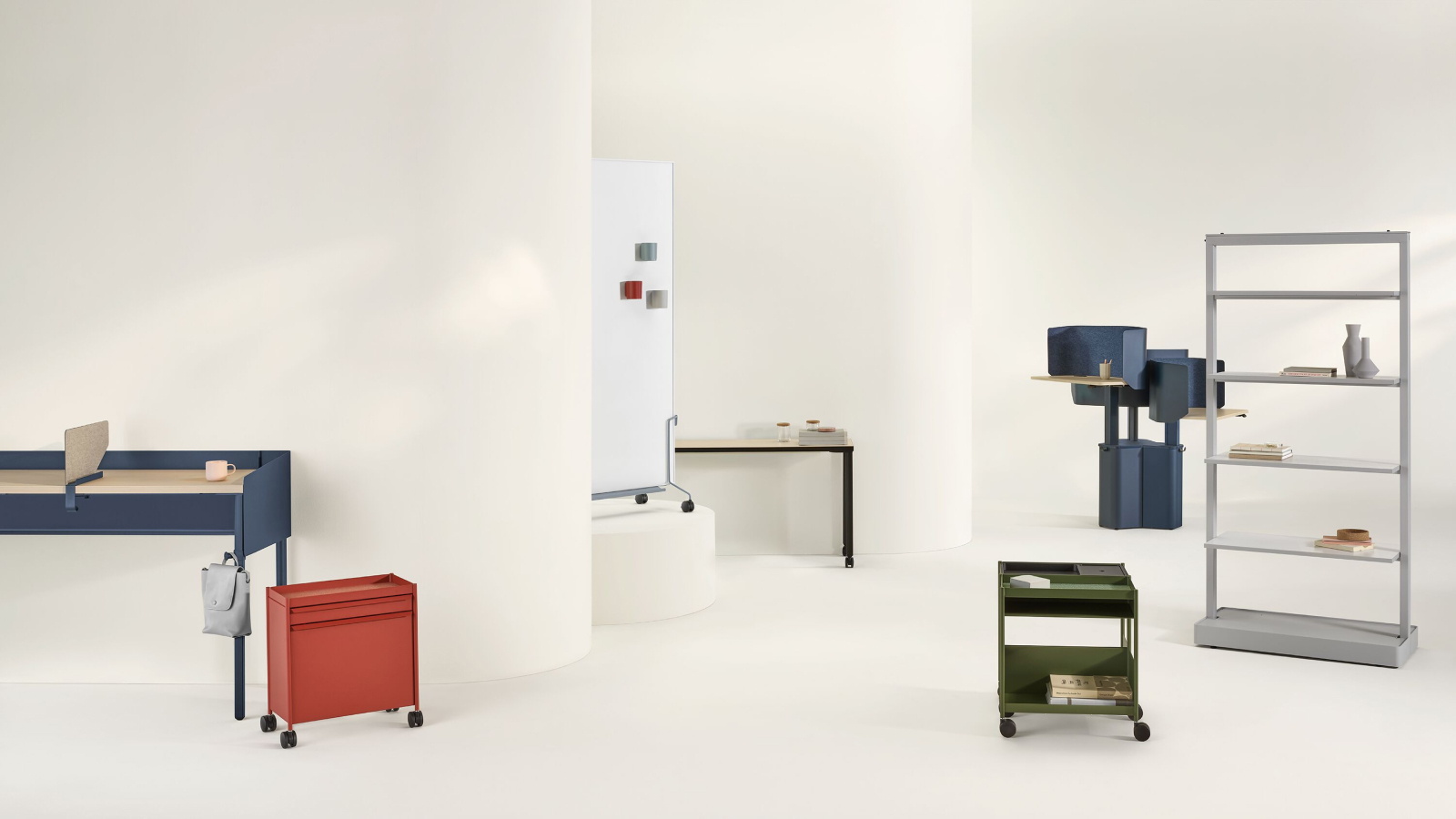 A collection of OE1 Workspace Collection products including OE1 Communal Table, OE1 Storage Trolleys, OE1 Agile Wall, OE1 Mobile Easel, OE1 Micro Pack and OE1 Rectangular Table in various colors.