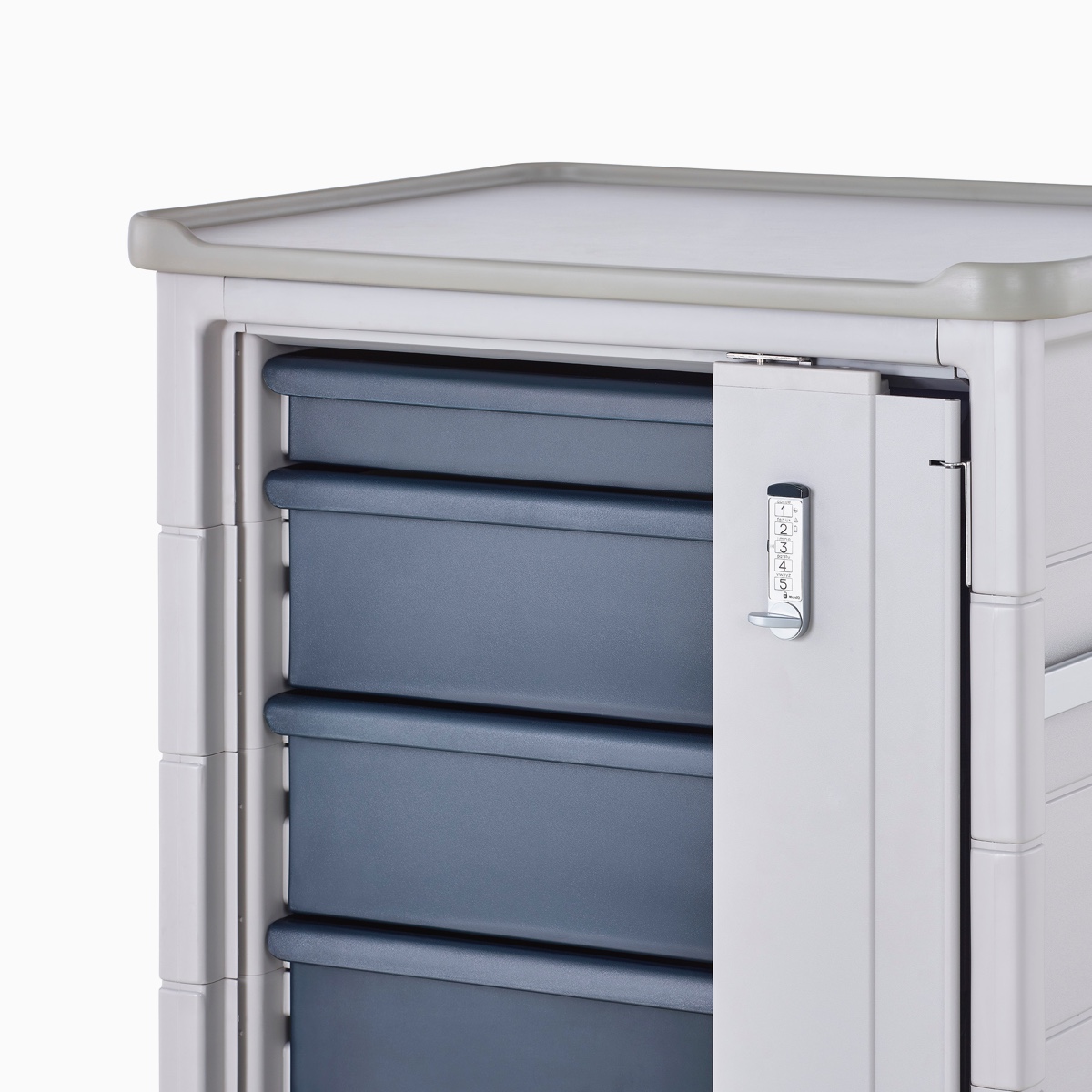Detail of Procedure and Supply Cart in a light gray body and dark blue modular drawers and lock bar with keyless lock.