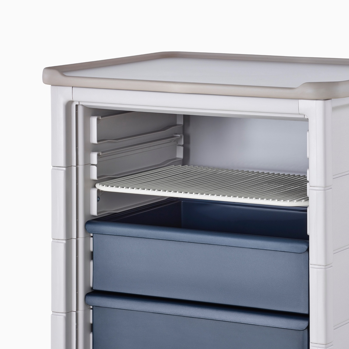 Detail of Procedure and Supply Cart in a light gray body and dark blue modular drawers with a soft white modular wire shelf.