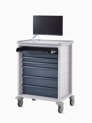 Angled view of technology cart in light gray finish with midnight blue drawers and a monitor mounted on monitor arm on top of the cart.