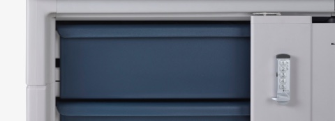 Detail of Procedure and Supply Carts materials, featuring a cart body in soft white and a cart body in a light gray with midnight blue drawers.