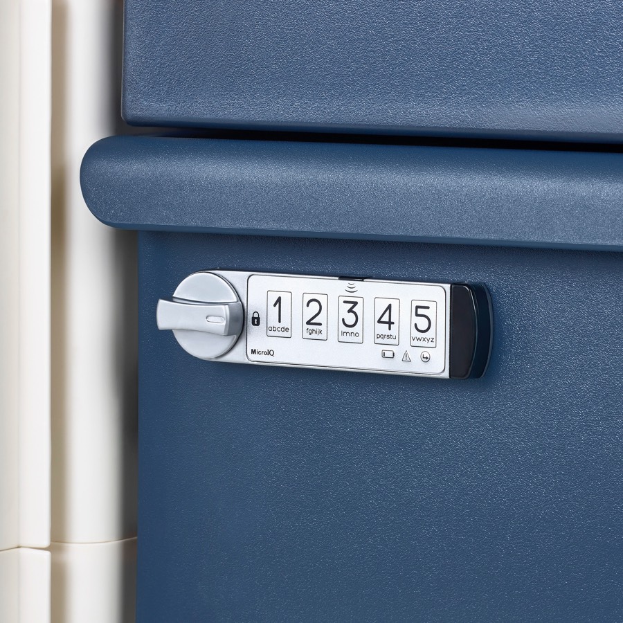 Detail of a keyless lock on a healthcare cart drawer.