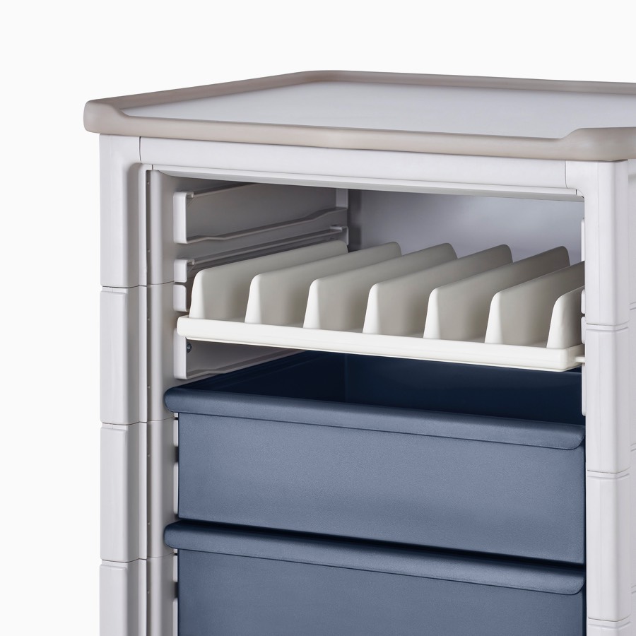 Detail of Procedure and Supply Cart in a light gray body, dark blue modular drawers, and a light gray modular shelf divider.