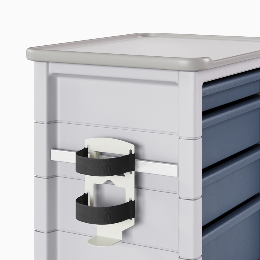 A supply cart with a gray body and midnight blue drawers with an adapter rail holding a sharps container holder.