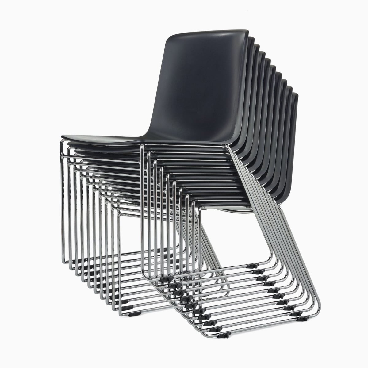 A stack of black Pronta chairs with chrome legs.