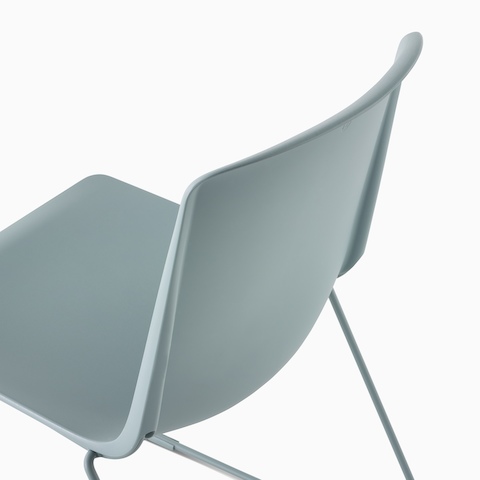 The back of a glacier colored Pronta Stacking Chair.