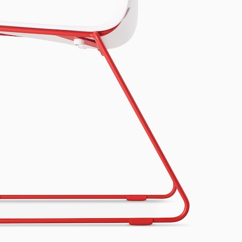 A close up of the Atomic Red base of a Pronta Stacking chair.