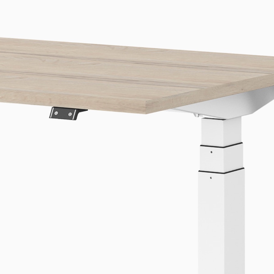 Close-up view of a Ratio height-adjustable desk with a switch.