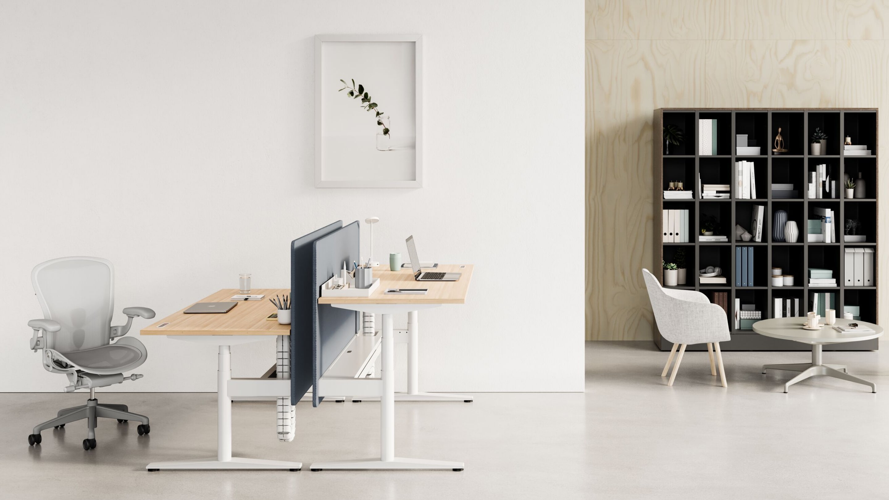 Back-to-back Ratio desks at both standing and seated heights with a light gray Aeron Chair. Two gray Saiba Chairs and an occasional height Civic Table are shown in front of a Port Storage System.