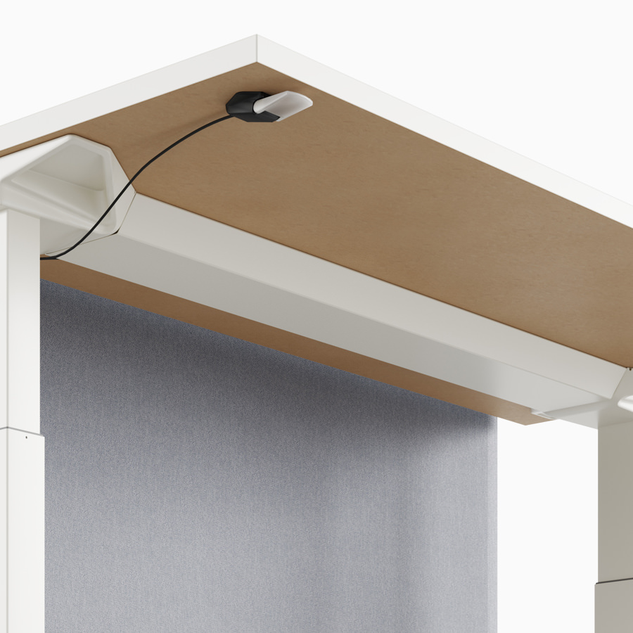 A close-up view of a Renew Link standing desk system's simple cable tray.