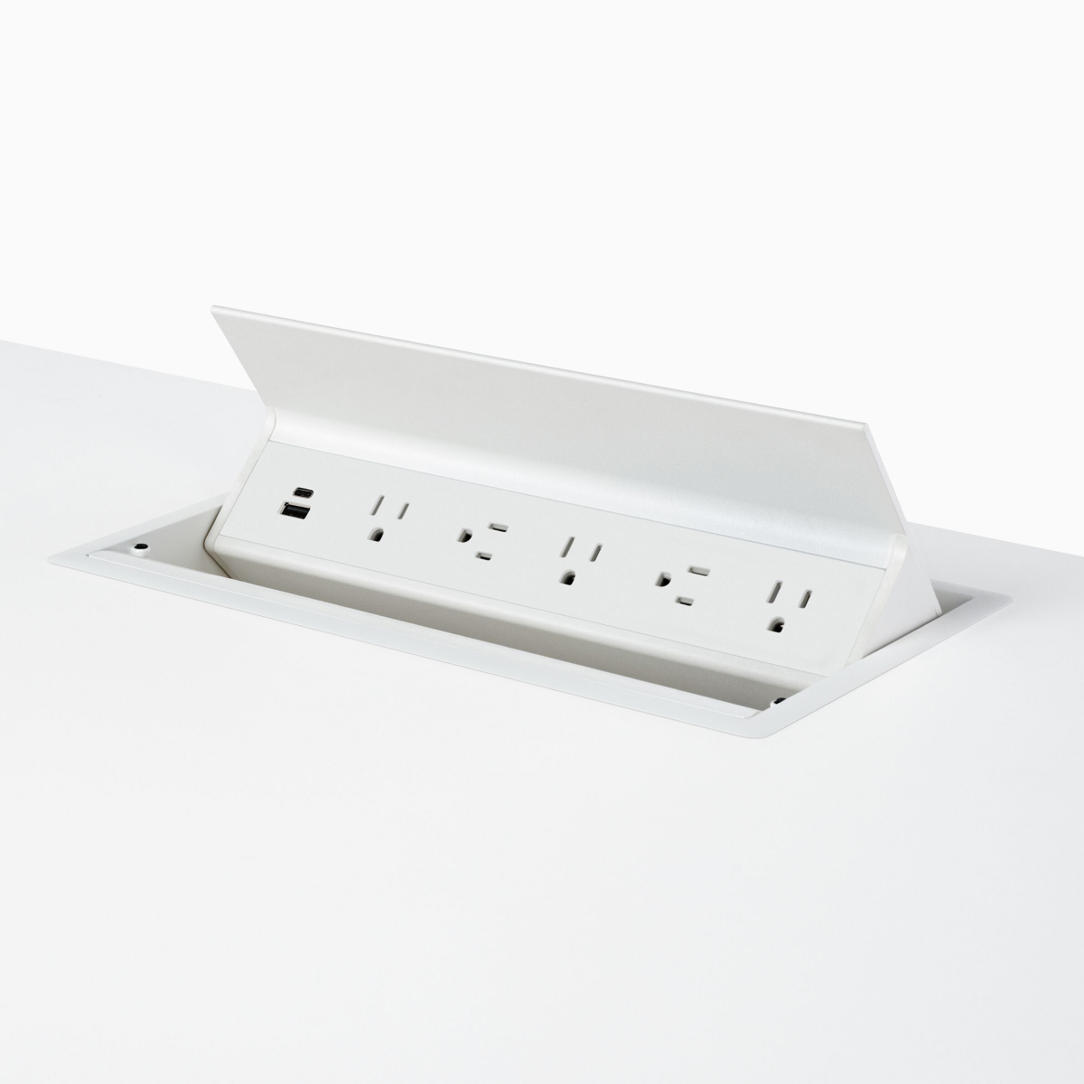 A white Logic G1000 with two USB connections and five power outlets integrated in the work surface of a Renew Sit-to-Stand Table.