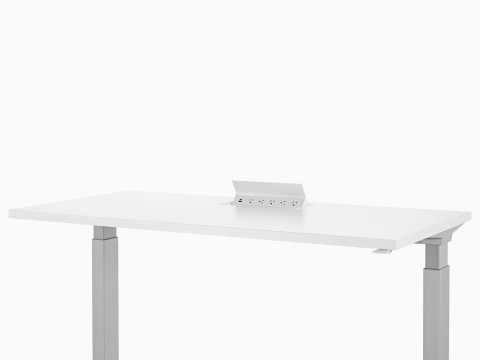 Logic power source with USB-A port, USB-C port, and five A/C power outlets embedded into white height adjustable table.