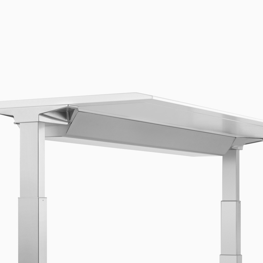 Viewed at an angle, a closed high-density cable tray that's attached to the underside of a Renew Sit-to-Stand Table's work surface.