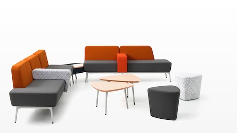 A Sabha Collaborative Seating arrangement, including two- and three-seat sofas in gray and orange with interior armrests.