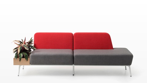 A two-seat Sabha Collaborative sofa with a red back, gray seat, and built-in planter.