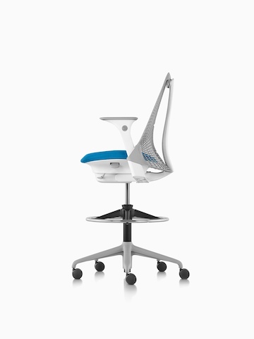 Profile view of a light gray Sayl Stool with a blue seat.